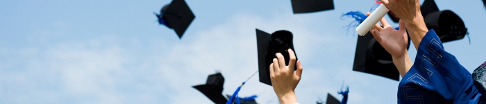 Graduation image, caps being thrown in the air
